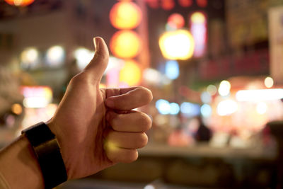 Close-up of hand holding illuminated text