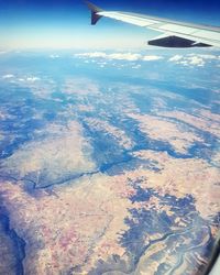 Cropped image of airplane flying over landscape