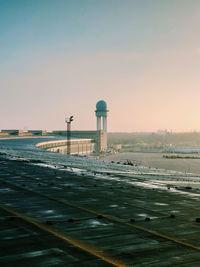 View of airport runway against sky during sunset