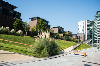 Buildings in city against blue sky