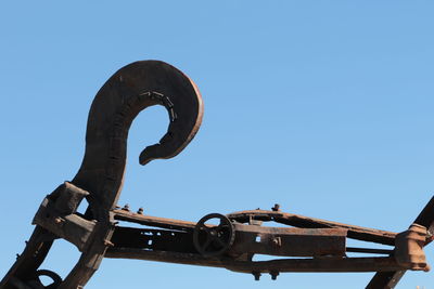 Low angle view of old train against clear blue sky