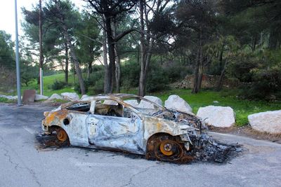 Abandoned car on road