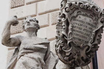 Close-up of angel statue against wall