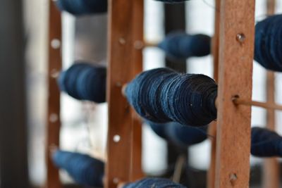 Close-up of spools on wood