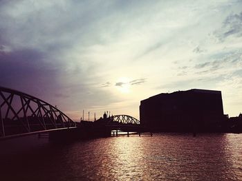 Bridge over river at sunset