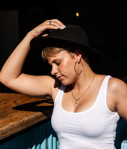 Woman wearing hat while sitting at table