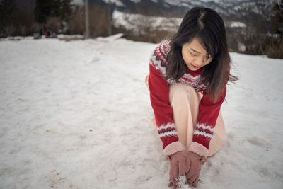 Full length of woman playing in snow