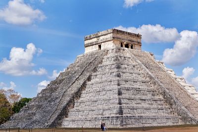 Low angle view of monument against cloudy sky