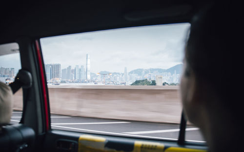 Close-up of cityscape seen through car window