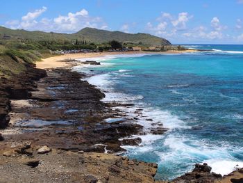 View of beach against cloudy sky