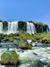 Scenic view of waterfall against clear sky