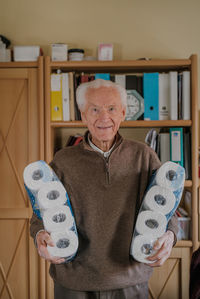 Portrait of smiling man standing at home