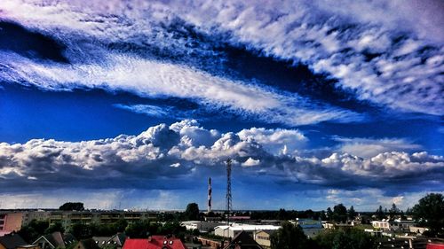 Buildings against cloudy sky