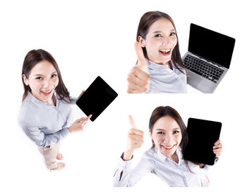 Portrait of smiling young woman using phone against white background