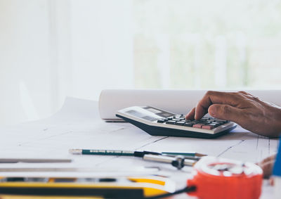 Midsection of man working on table