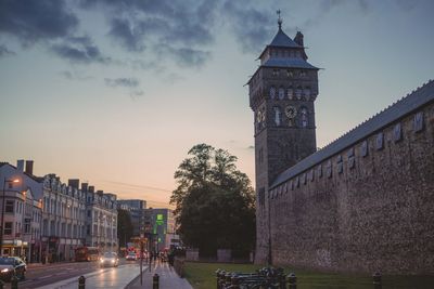 View of city lit up at sunset