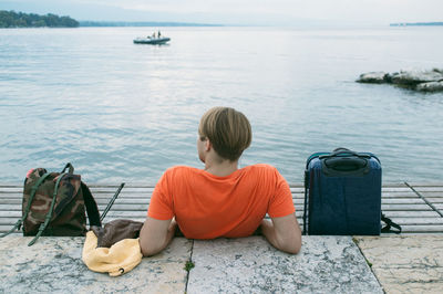 Rear view of people sitting on beach