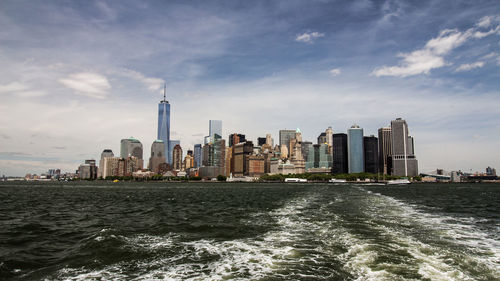 Scenic view of sea and buildings against sky