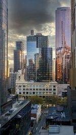 High angle view of buildings in city against dramatic sky