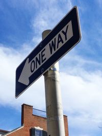 Low angle view of sign board against cloudy sky