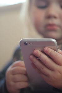 Close-up of girl using smart phone