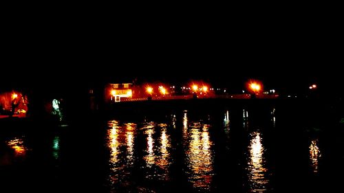 Reflection of illuminated lights in puddle