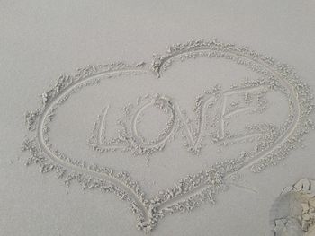 Close-up of heart shape on sand
