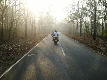 People riding bicycle on road