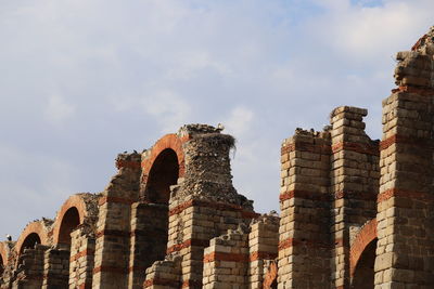 Low angle view of historical aqueduct against sky