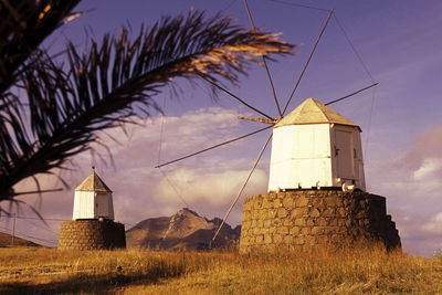 Traditional windmills against sky