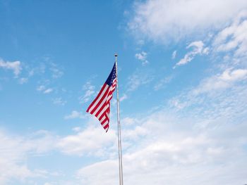 Low angle view of american flag against sky