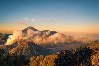 Smoke emitting from volcanic mountain against sky