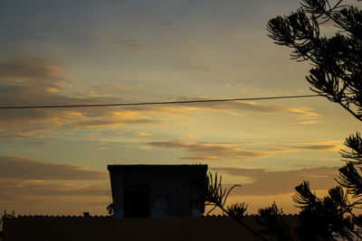 Low angle view of silhouette building against sky at sunset