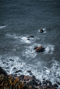 High angle view of rocks in sea