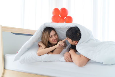 Young couple lying on bed