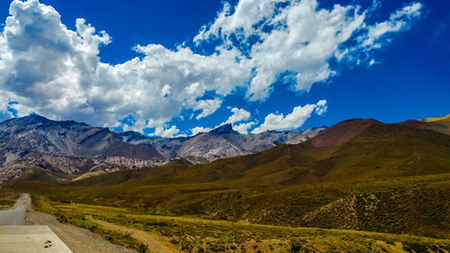 Scenic view of snowcapped mountains against blue sky