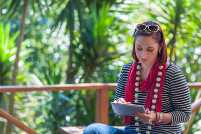 Woman using tablet outdoors