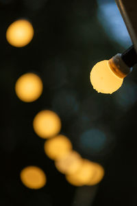 Cropped hand holding illuminated light