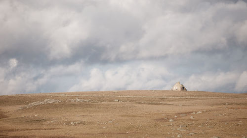 Scenic view of a house on field against sky