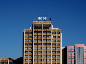 Low angle view of building against clear blue sky