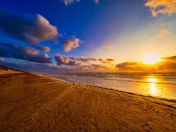 Scenic view of beach against sky during sunset