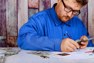 Midsection of man working on table