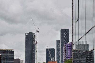 Modern buildings in city against sky