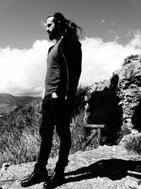 Full length of woman standing on land against sky