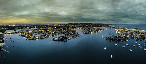 High angle view of cityscape by sea against sky