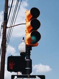 Low angle view of road signal against sky