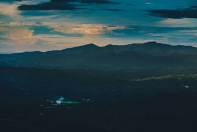 Scenic view of mountains against sky at night