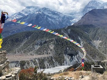 Scenic view of snowcapped mountains against cloudy sky