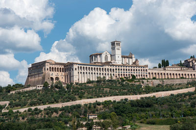 Buildings against cloudy sky