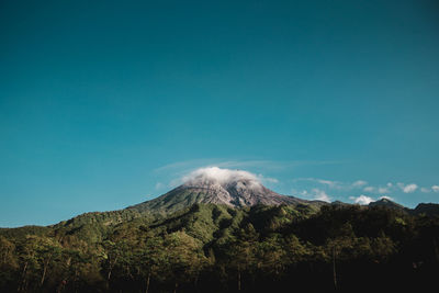 Low angle view of mountain against blue sky